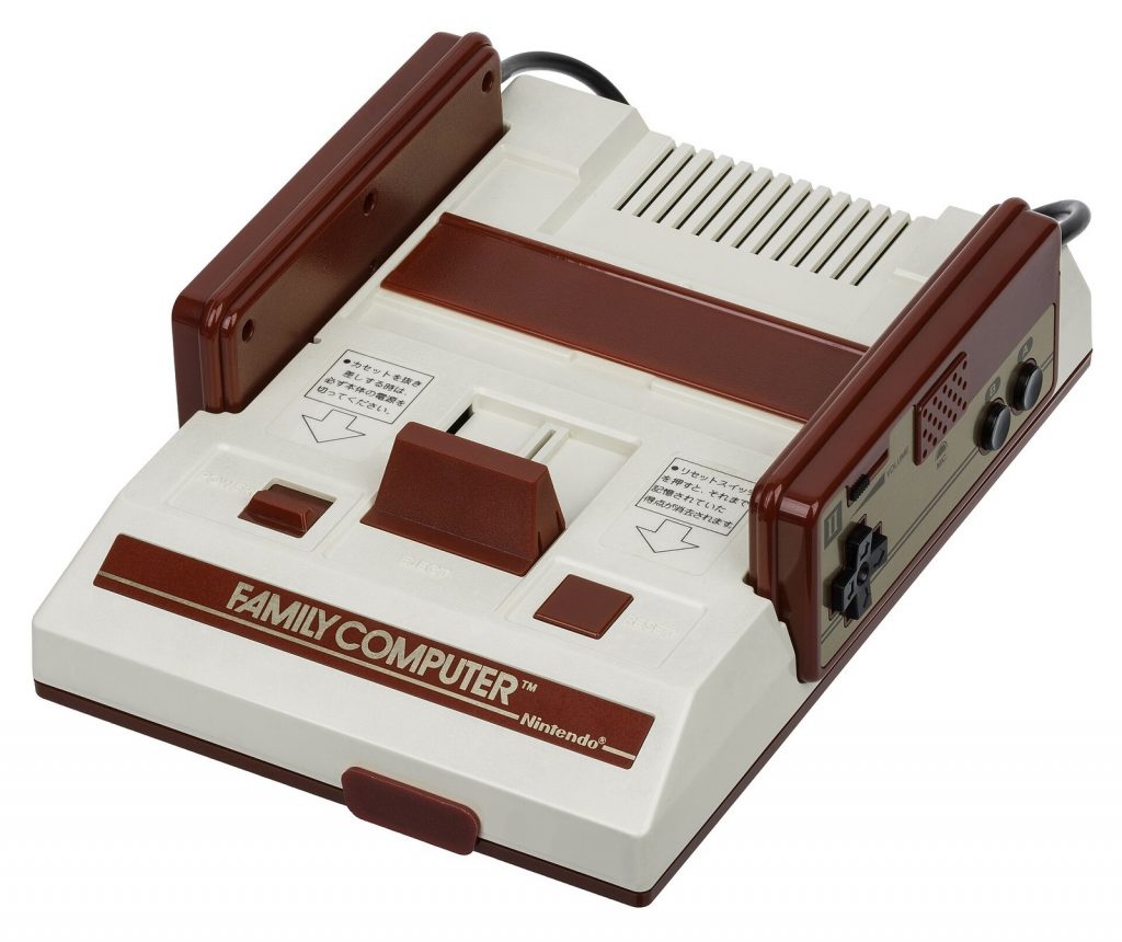 Red and white Nintendo Famicom console with its two wired controllers